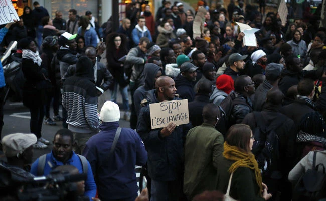 Protesters demonstrate against slavery in Libya outside the Libyan Embassy in Paris on Friday, Nov. 24, 2017. (AP Photo/Thibault Camus)
