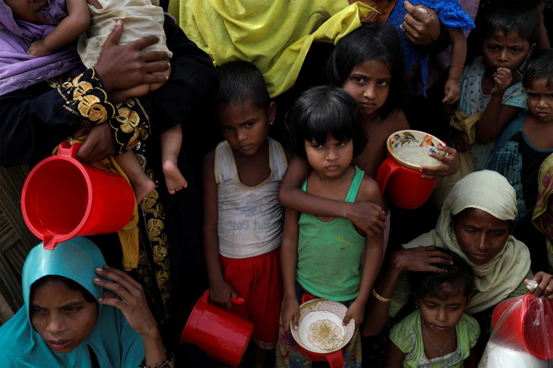 Rohingya women and children wait to get distributed meals at Moynarghona refugee settlement near Cox’s Bazar, Bangladesh. More than 600,000 Rohingya sought sanctuary in Bangladesh after Myanmar’s military launched a brutal counter insurgency in their villages. (Reuters)