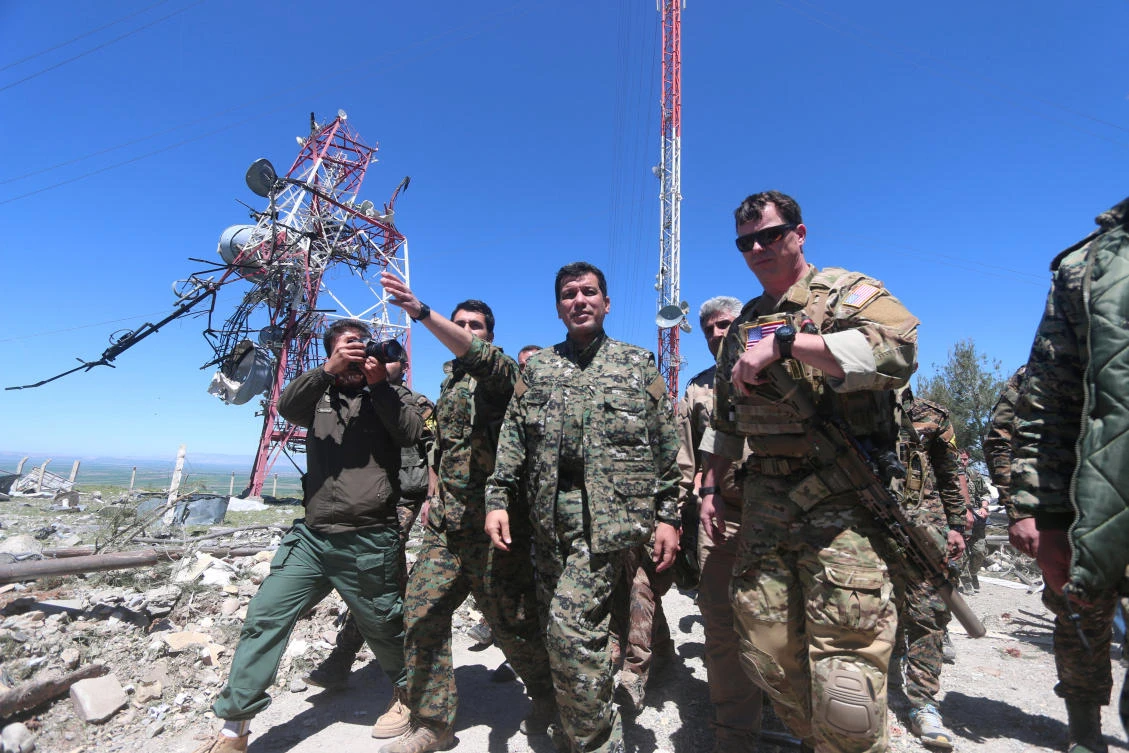 Above, a US military commander, right, walks with a commander from the Kurdish People’s Protection Units as they inspect the damage at YPG headquarters after it was hit by Turkish airstrikes in Mount Karachok near Malikiya, Syria on April 25, 2017. (Reuters)