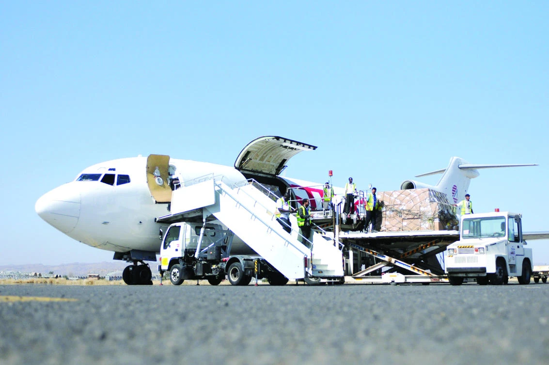 Workers unload aid shipment from a plane at Sanaa airport on Saturday. (Reuters)