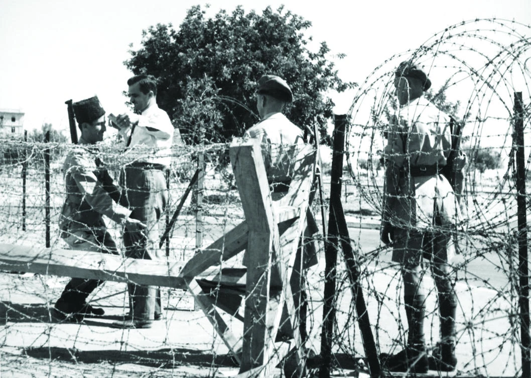 This June 1, 1947, photo shows two British soldiers , right, and a Palestinian policeman, left, searches a man at an entrance of Jerusalem’s B-Zone during the British mandate in Palestine. (AFP)