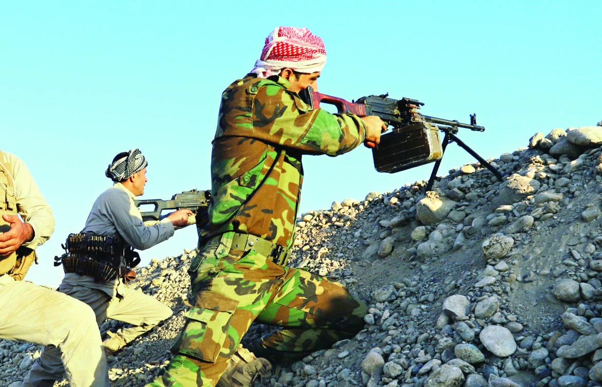 Peshmerga fighters take aim from their position at the Altun Kubri checkpoint, 40 km from Kirkuk, in this Oct. 20 photo. (AFP)
