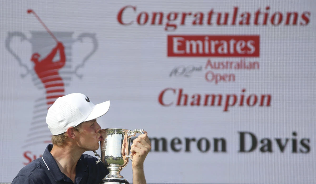 Australia's Cameron Davis kisses his trophy after winning the Australian Open Golf tournament in Sydney on Sunday, November 26. The 22-year-old charged home to beat his more experienced rivals and capture his first professional title. (AP)