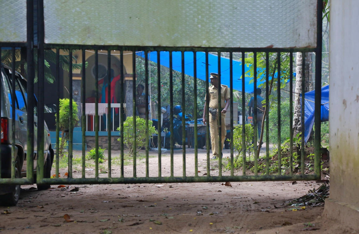 Above, police officers guard the premises of K M Ashokan, father of 24-year-old Akhila, who converted to Islam in 2016 after marrying a Muslim man, at Vaikom in the Kottayam district of the southern state of Kerala. (Reuters)