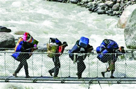 Backpackers cross the Bhote Koshi river. Nepal’s rivers have
vast, untapped potential for hydropower generation. (Reuters)