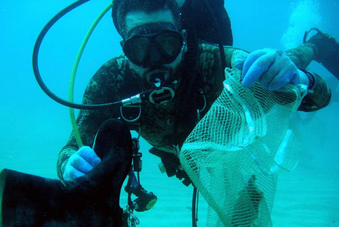 A Lebanese diver takes part in cleaning the seabed off the coastal city of Batroun, north of Beirut. (File photo/AFP)