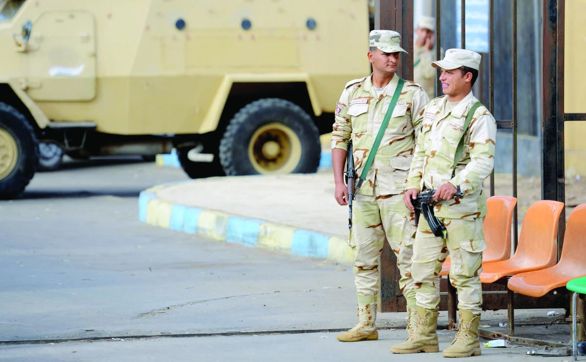 Egyptian security personnel stand guard outside a hospital in Ismailia on Saturday. (AFP)