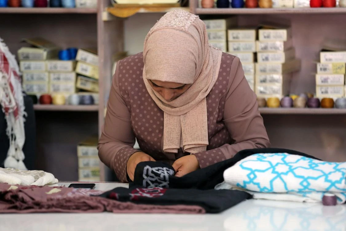 A Palestinian woman embroiders at a workshop in Jordan’s Jerash Palestinian refugee camp, which was established to host more than 11,000 Palestinians who fled the Gaza Strip during the 1967 Arab-Israeli war, north of Amman on November 5, 2017. (AFP)