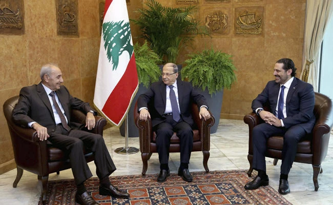 Lebanese President Michel Aoun, center, meets with Prime Minister Saad Hariri, right, and Parliament Speaker Nabih Berri at the Presidential Palace in Baabda, east of Beirut, Lebanon, on Monday, Nov. 27, 2017. A(Dalati Nohra/Lebanese government via AP)