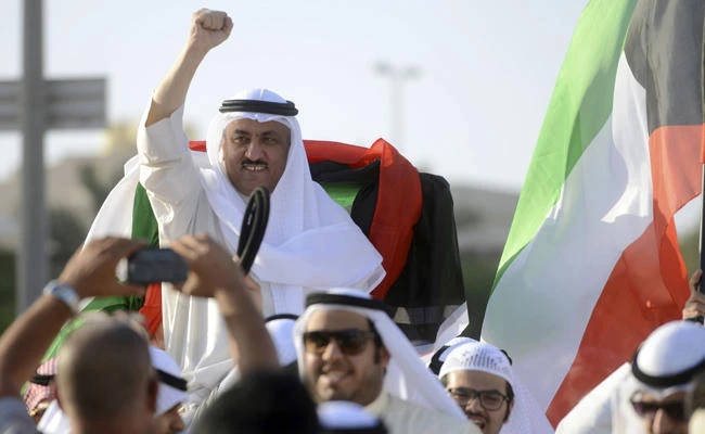 In this April 20, 2015 file photo, supporters celebrate with opposition leader Musallam al-Barrack in Kuwait City after his release on bail ahead of a final decision on charges he insulted the country's ruler. A lawyer said Monday Nov. 27, 2017, that a Kuwaiti appeals court has sentenced al-Barrack to seven more years in prison, after being freed on another conviction in April this year. (AP Photo, File)