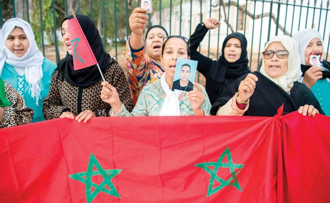 Moroccans call for the return of their relatives who migrated to Libya, during a protest in Rabat on Monday. (AFP)