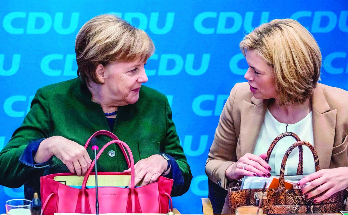 German Chancellor Angela Merkel, left, and Christian Democratic Union (CDU) party politician Julia Kloeckner chat prior to a meeting in Berlin on Monday. (AFP)