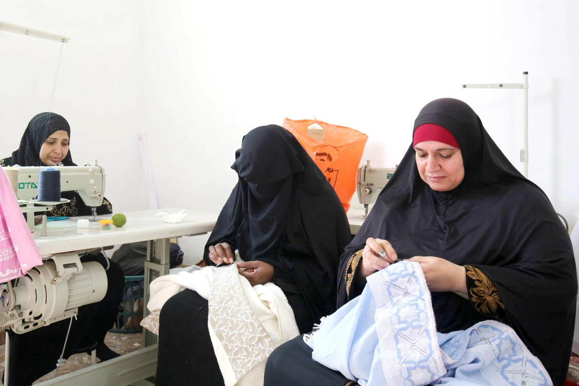 Palestinian women embroider at a workshop in Jordan’s Jerash Palestinian refugee camp. (AFP)