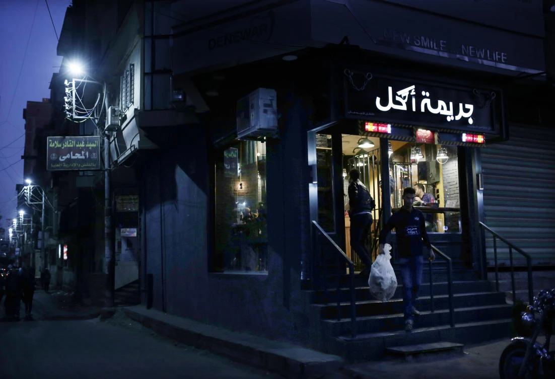 In this Nov. 22, 2017 photo, a waiter takes out the trash at prison-themed restaurant ‘Food Crime,’ in the Nile Delta city of Mansoura, 110 kilometers (70 miles) north of Cairo, Egypt. A prison-themed restaurant in Egypt? It might seem distasteful in a country where, according to rights groups, thousands of people, mostly Islamists but also secular pro-democracy activists, are languishing in jail on trumped-up charges. (AP Photo/Nariman El-Mofty)