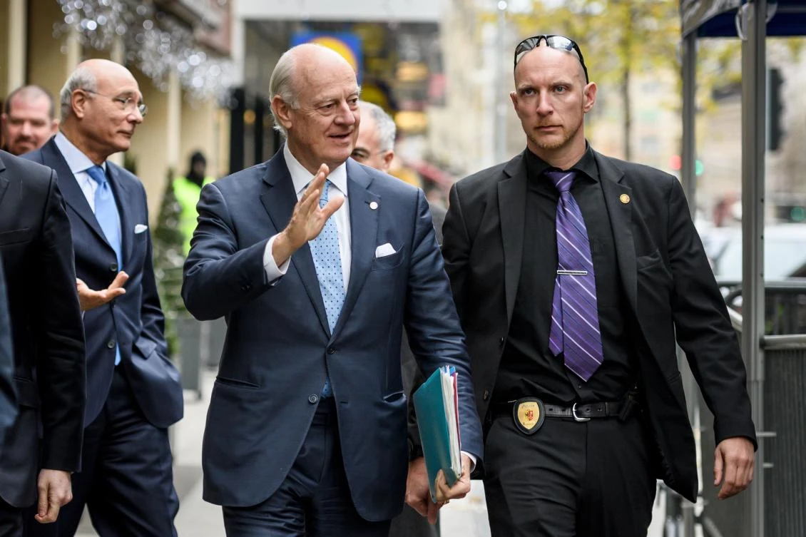 United Nations Special Envoy for Syria Staffan de Mistura (C) gestures upon his arrival to meet Syria’s opposition delegation prior to a new round of peace talks on Nov. 28, 2017 in Geneva. The United Nations reopens its Syria peace talks, but the Damascus government’s last minute announcement that it may not come to Geneva delivered a blow to the already faltering negotiations. (AFP/Fabrice Coffrini)