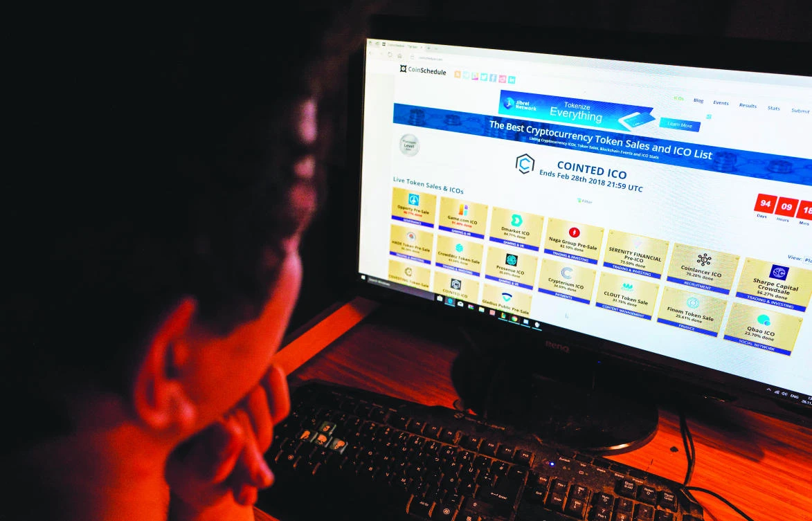 A computer screen displays a site featuring cryptocurrency token sales in Berlin on Nov. 26, 2017. Bypassing oversight of any kind, Initial Coin Offerings (ICOs) have sprung from nowhere to become a hugely popular way for start-ups to raise funds online, offering self-created digital ‘tokens’ or coins to any willing buyer. (AFP)