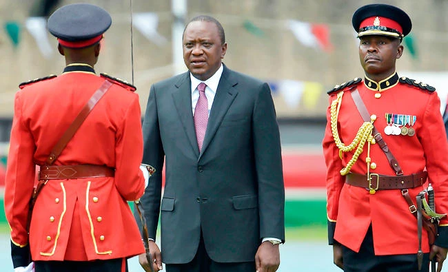Newly re-elected Kenyan President Uhuru Kenyatta reviews a guard of honour during his inauguration ceremony for a second term at Kasarani Stadium on November 28, 2017 in Nairobi. Kenyatta vowed to be the leader of all Kenyans and work to unite the country after a bruising and drawn out election process that ended with his swearing-in. / AFP / SIMON MAINA
