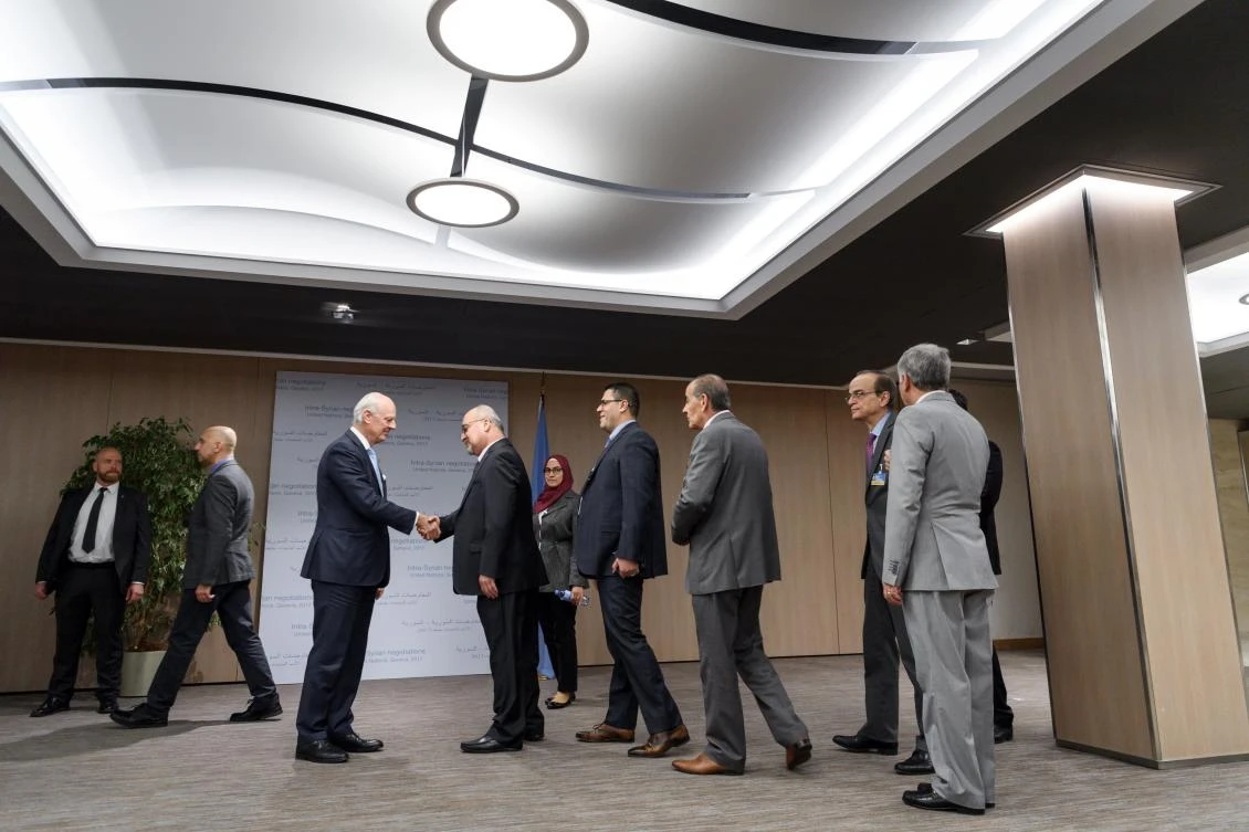 UN Special Envoy for Syria Staffan de Mistura (3rdL) shakes hands with members of the opposition delegatio on the opening of a new round of Syria’s peace talk on Nov. 28, 2017 at the United NatIons Office in Geneva. (AFP/POOL/Fabrice Coffrini)