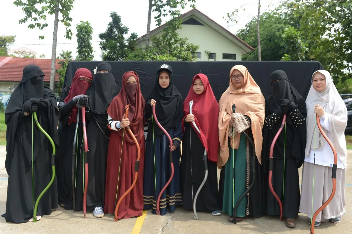 This picture taken on November 12, 2017 shows Indonesian Muslim women posing for a photograph after participating in archery and horse riding lessons in Bekasi. Riding a horse or nailing an archery target is tough at the best of times -- it's even harder when you're wearing a niqab. But that isn't about to stop a group of Indonesian women who have banded together as they face prejudice against the face-covering veil at the centre of a heated global debate over religious freedom and women's rights. (AFP)