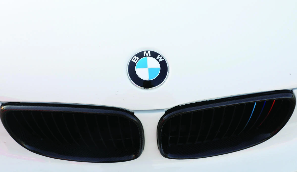 A BMW logo is seen on a car at the International Auto Show in Mexico City last week. The automaker is seeking partners to develop small electric cars. (Reuters)