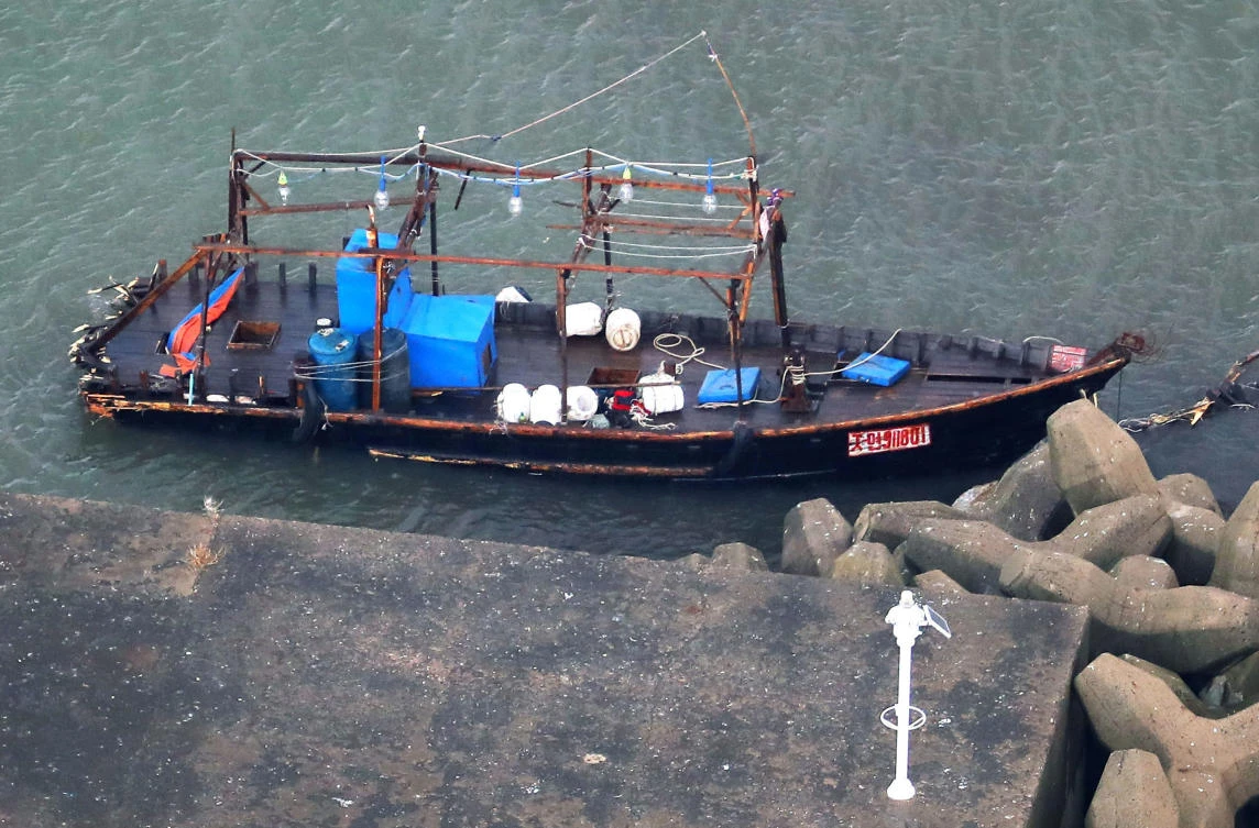 A wooden boat is moored at a nearby marina, in Yurihonjo, Akita prefecture, northern Japan, Friday, Nov. 24, 2017. Japanese police are investigating eight men found on Japan's northern coast who say they are from North Korea and washed ashore after their boat broke down. Akita prefectural police said Friday they found the men late Thursday after receiving a call that a group of suspicious men were standing around at the seaside in Yurihonjo town. Police also found the wooden boat at the marina. (Kyodo News via AP)