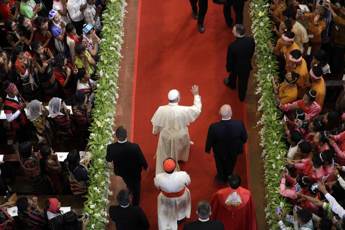 Pope Francis, center, arrives to celebrate a mass in St. Mary’s Cathedral in Yangon, Myanmar. Pope Francis has so far refrained from speaking out about Asia’s worst humanitarian crisis in decades (AP)