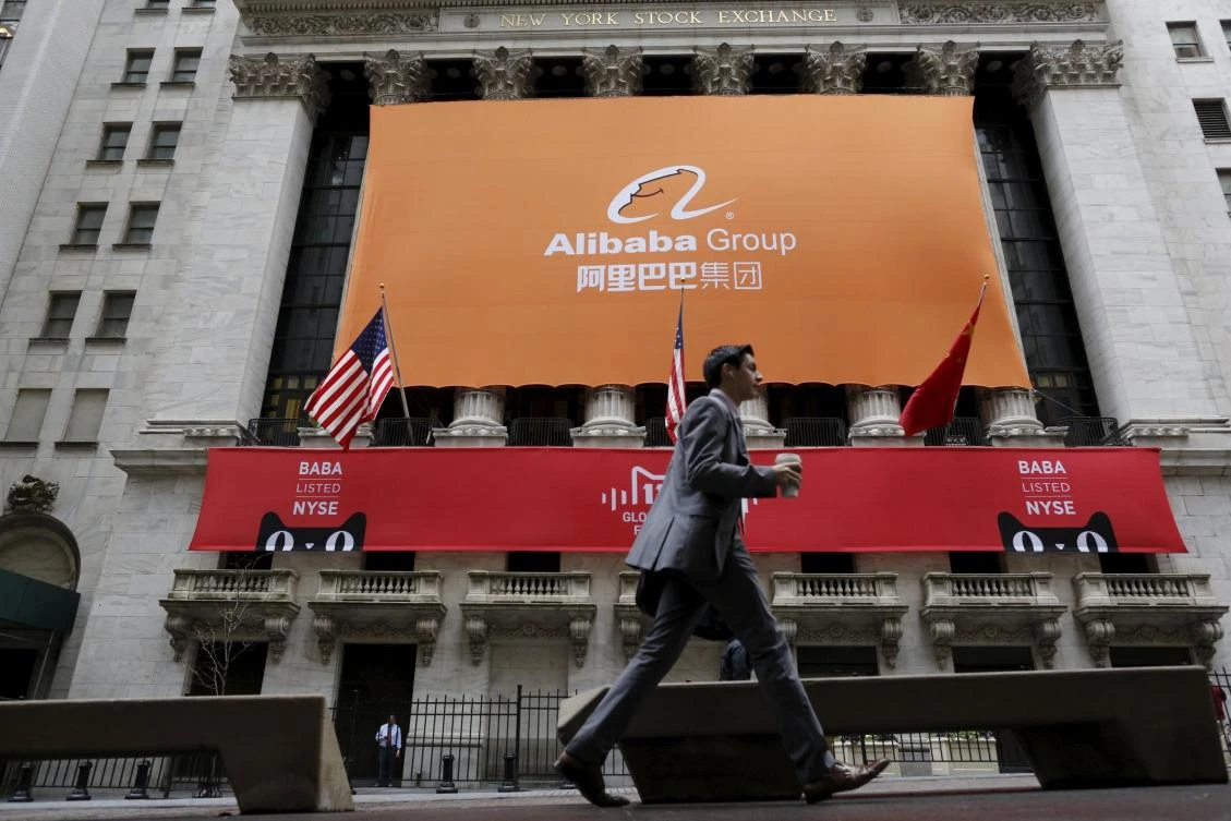 Above, a signage for Alibaba Group Holding covers the front facade of the New York Stock Exchange, which made a history when it recorded one of the biggest technology IPO amounting $25 billion. (Reuters)