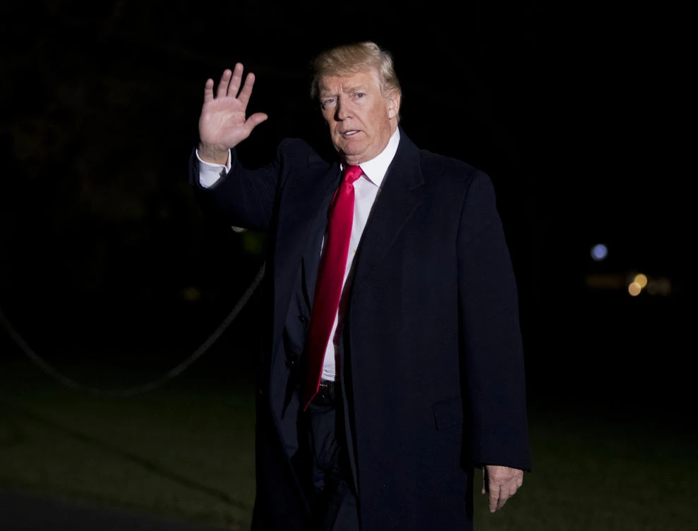 President Donald Trump waves as he walks on the South Lawn upon his return to the White House in Washington from a trip to Missouri on Wednesday, Nov. 29, 2017. (AP Photo/Manuel Balce Ceneta)
