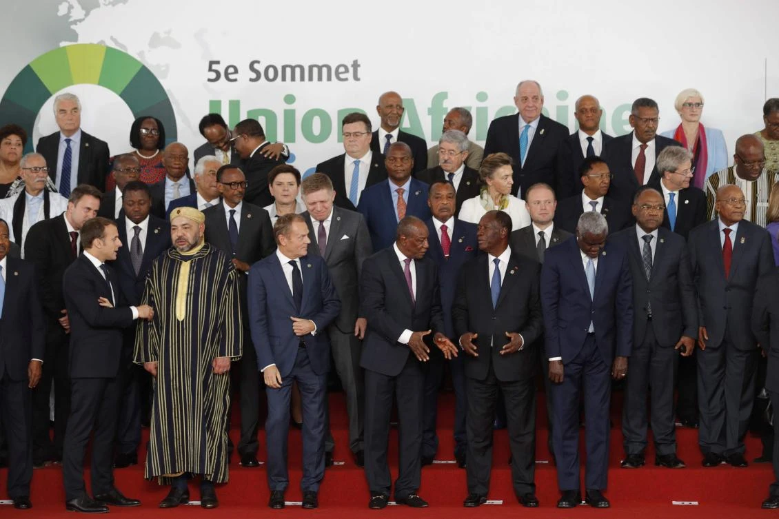 (From L — 1st row) French President Emmanuel Macron, King Mohammed VI of Morocco, European Council President Donald Tusk, Guinea’s President Alpha Conde, Ivory Coast President Alassane Ouattara, and African Union (AU) Commission chairman Moussa Faki pose as leaders gather for the family photo during the 5th African Union — European Union (AU-EU) summit in Abidjan, on November 29, 2017. Ivory Coast President opened a Europe-Africa summit on November 29, calling for “all urgent measures” to end migrant abuses, including slave trading in Libya. (AFP/POOL/Philippe Wojazer)