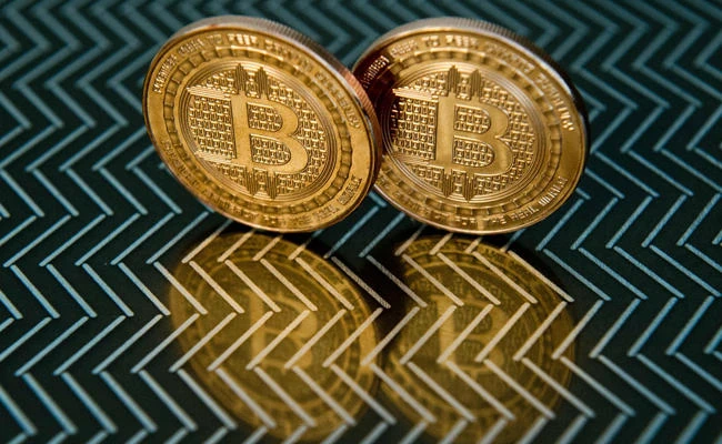 This June 17, 2014 file photo taken in Washington, DC shows bitcoin medals. (AFP / KAREN BLEIER)