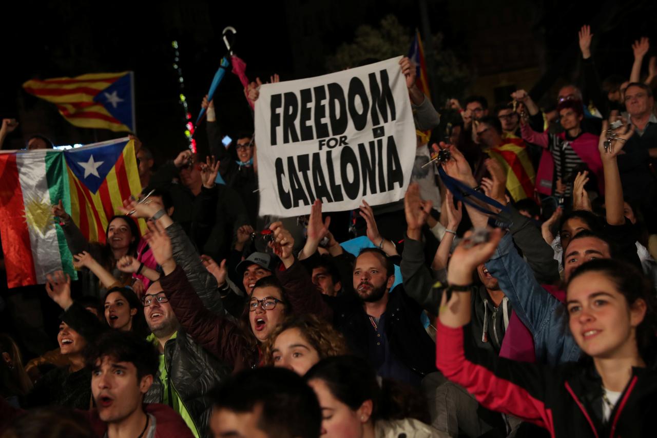 October 1, 2017 — People react as they gather at Plaza Catalunya after voting ended for the banned independence referendum, in Barcelona, Spain. (REUTERS)