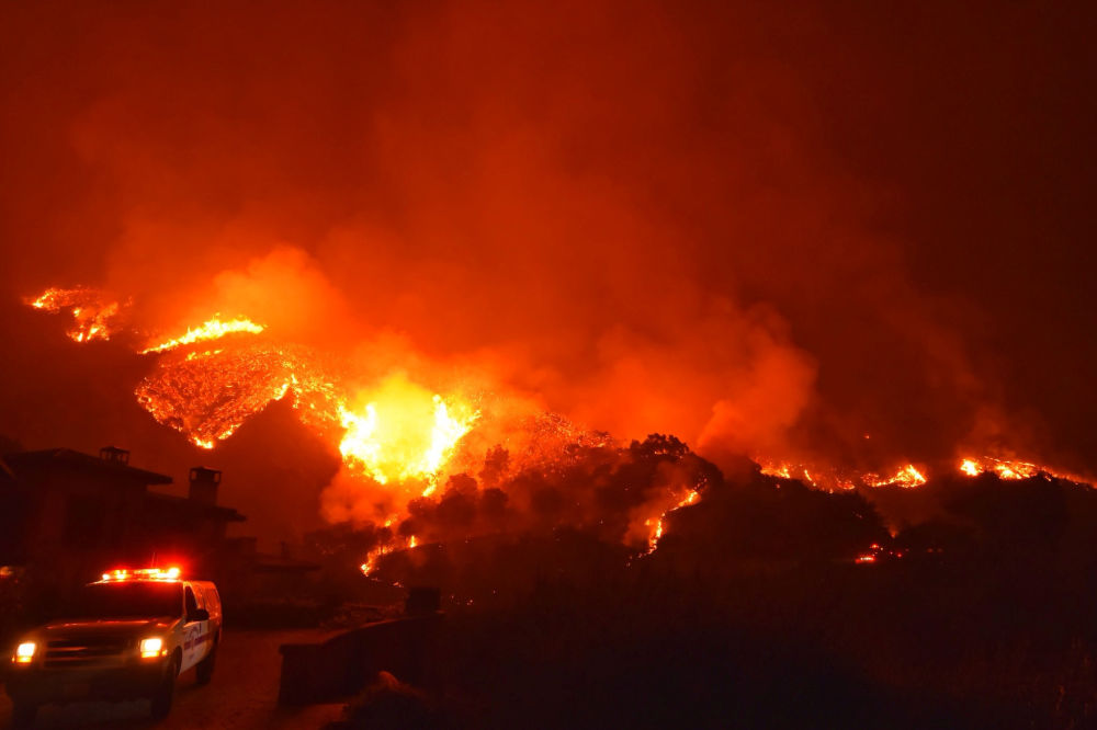 December 12, 2017 — Thomas wildfire burns above Bella Vista Drive near Romero Canyon in this social media photo by Santa Barbara County Fire Department in Montecito, California. (Santa Barbara County Fire Department via REUTERS)