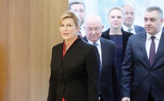 Croatian President Kolinda Grabar-Kitarovic and her advisers arrive to address a press conference in Zagreb on
Thursday. (AFP)