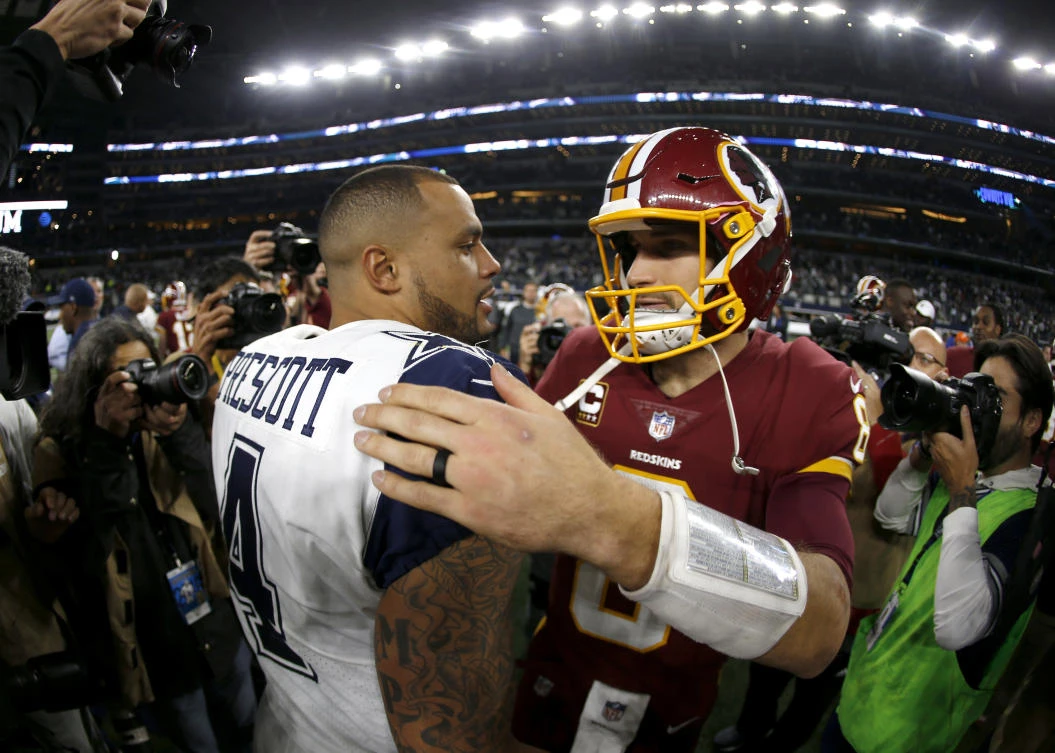 Dallas Cowboys quarterback Dak Prescott (4) and Washington Redskins quarterback Kirk Cousins (8) greet each other at midfield after their NFL football game, Thursday, Nov. 30, 2017, in Arlington, Texas. (AP Photo/Ron Jenkins)