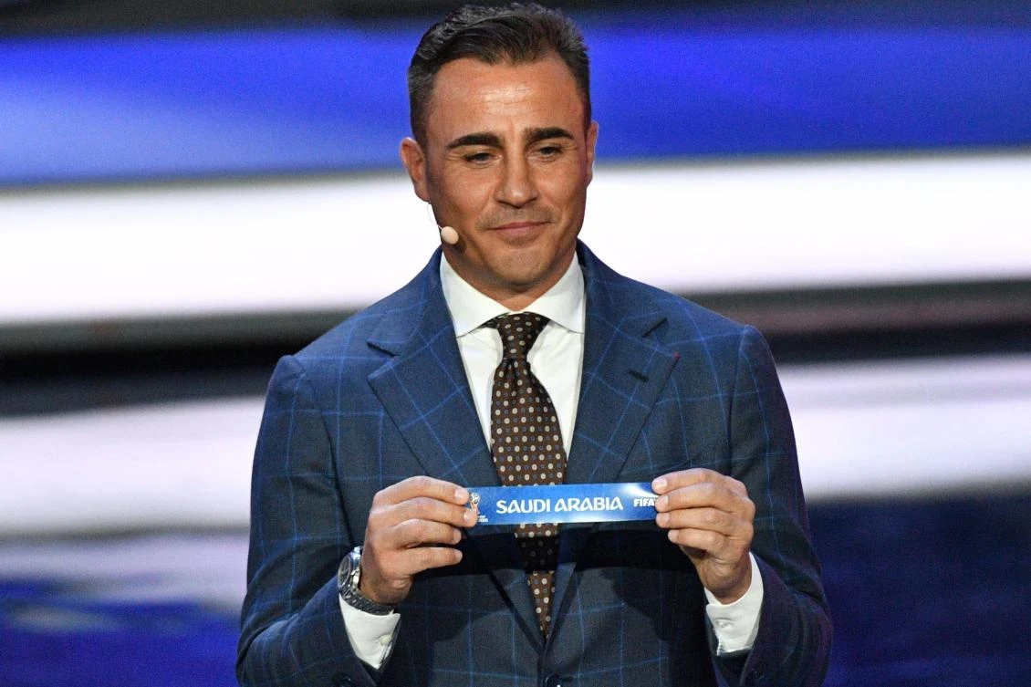 Italy's former defender and Guangzhou Evergrande's coach Fabio Cannavaro displays the slip of Saudi Arabia during the Final Draw for the 2018 FIFA World Cup football tournament at the State Kremlin Palace in Moscow on Friday, December 1, 2017. The 2018 FIFA World Cup will be held from June 14 and July 15, 2018, in 11 Russian cities. (AFP / Mladen Antonov)