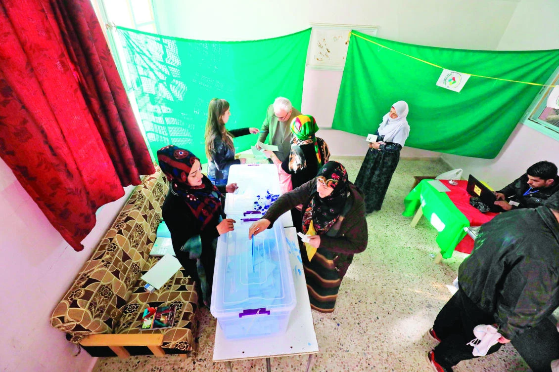 Syrians cast their votes in local elections held in Qamishli on Friday. (AFP)