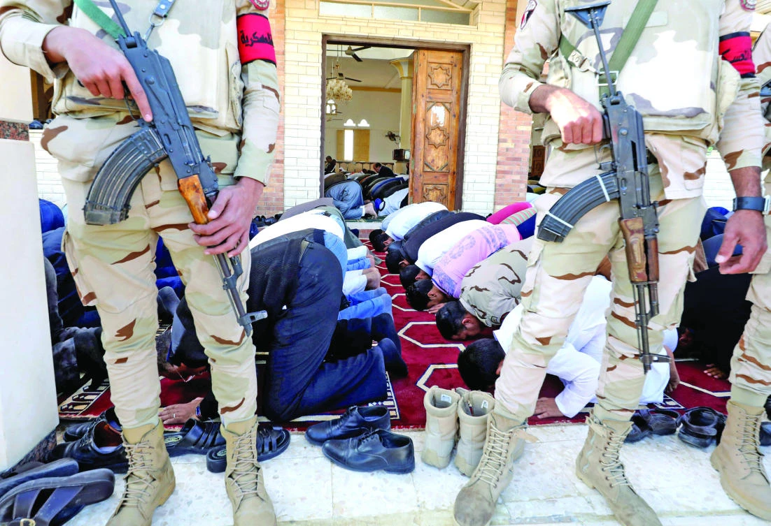 Troops protect worshippers outside Al-Rawdah mosque during the first Friday prayer after the attack in Bir Al-Abed,
Egypt, on Friday. (Reuters)