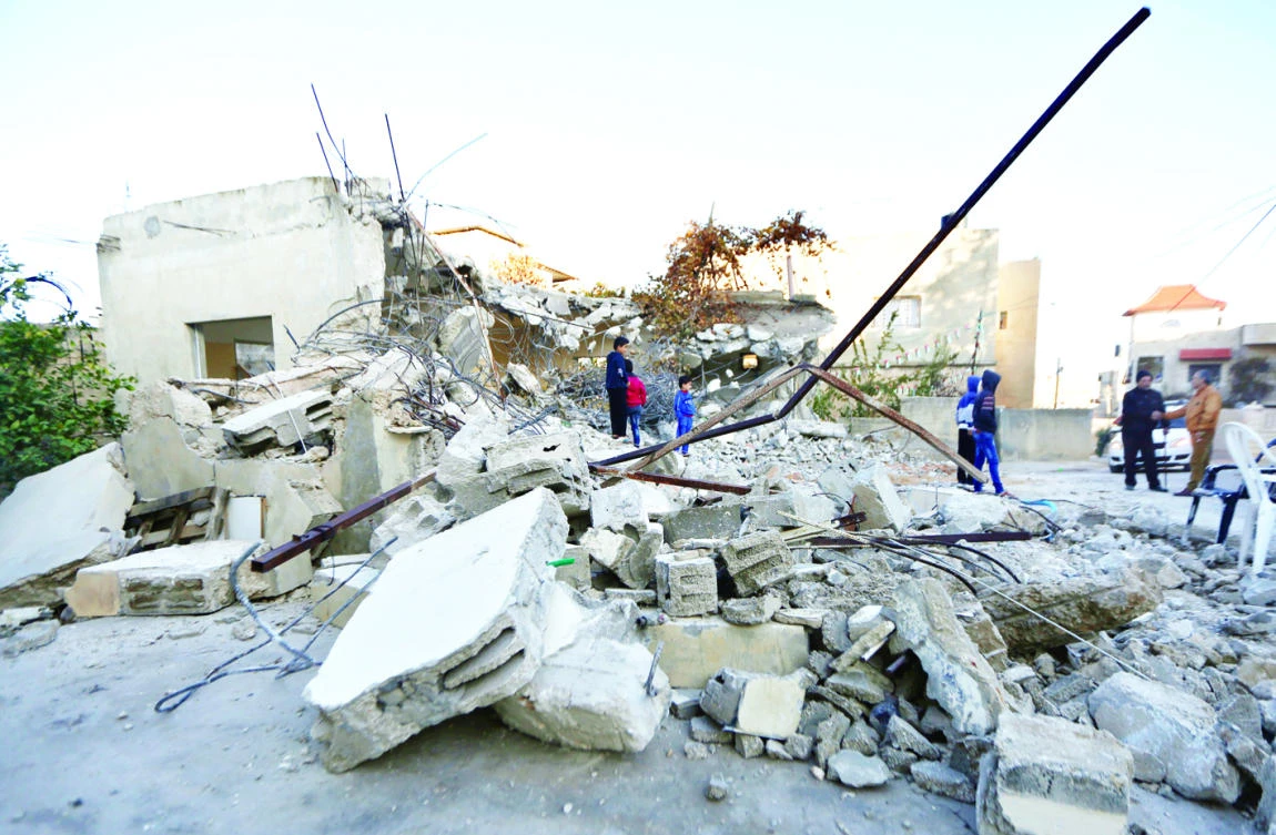 Palestinian boys inspect the house of Mohammed Abu Al-Rub after it was demolished by the Israeli Army, in the West Bank village of Qabatiya near the city of Jenin, on Friday. (AP)