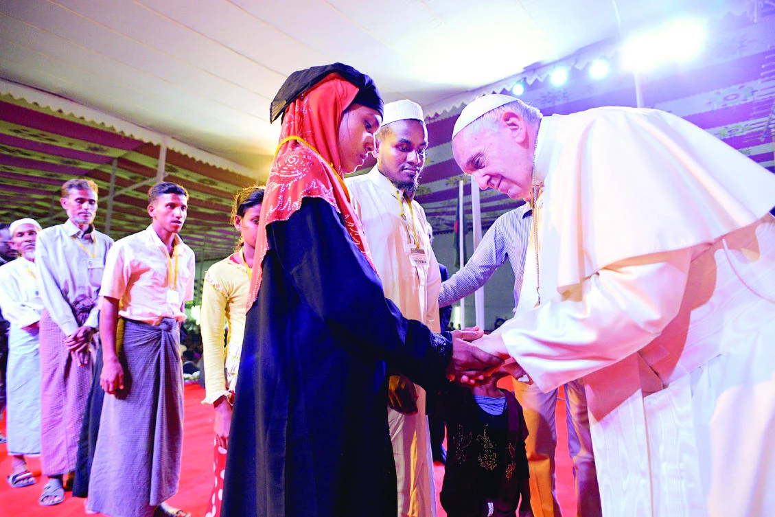 Pope Francis meets a group of Rohingya refugees during an inter-religious conference at St. Mary's Cathedral in Dhaka on Friday. (Reuters)