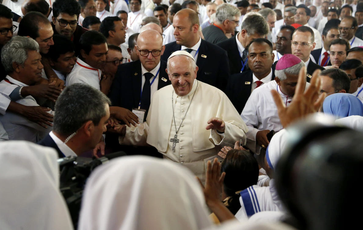 Bangladeshi Catholic nuns and priests greet Pope Francis, center, during his visit to Church of the Holy Rosary in Dhaka, Bangladesh on Saturday, December 2. (AP)