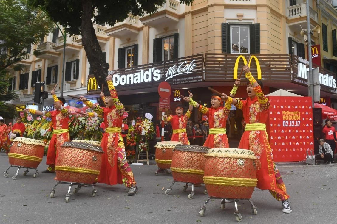 Performers beat drums during the opening ceremony of the first McDonald’s fast food chain restaurant in Hanoi on December 2. (AFP)