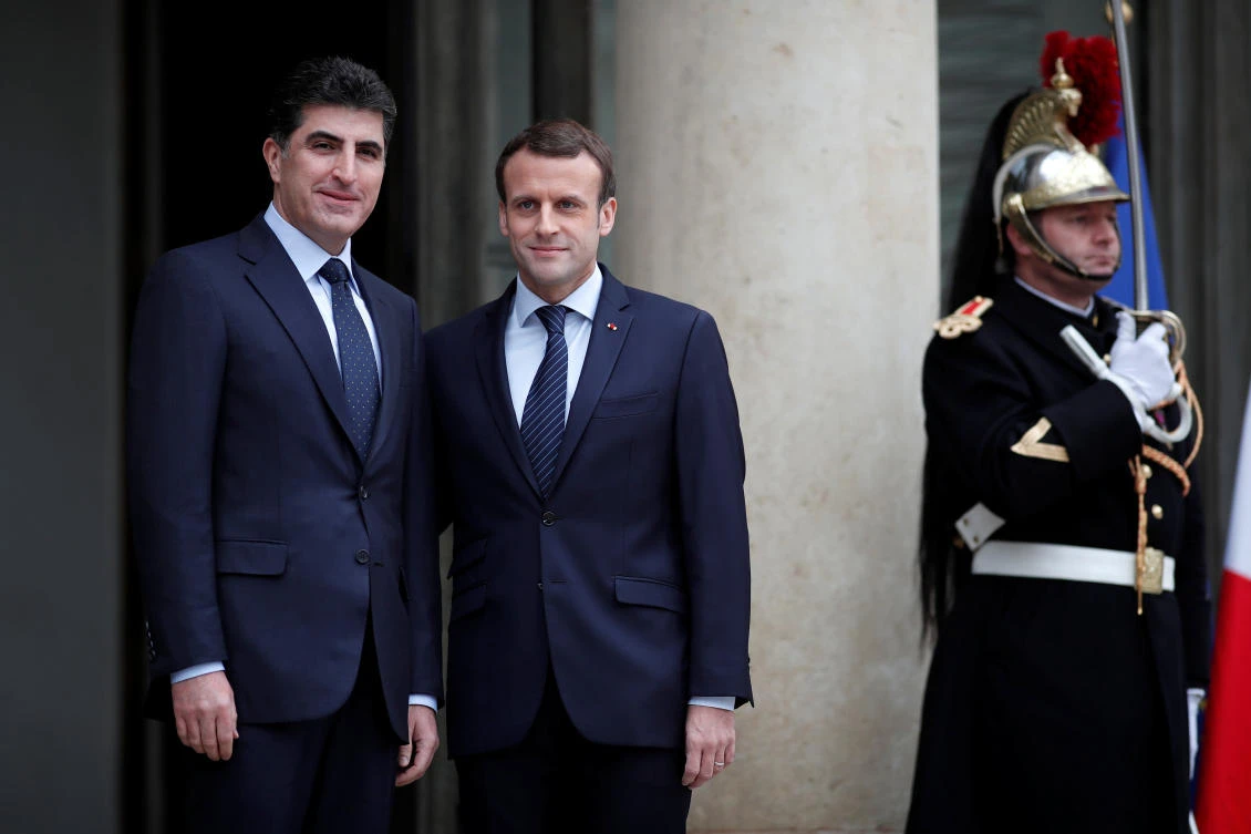 France's President Emmanuel Macron, right, welcomes Prime Minister of Iraq's autonomous Kurdish region Nechirvan Barzani, prior to a meeting at the Elysee Palace in Paris on Saturday, December 2. (Reuters)