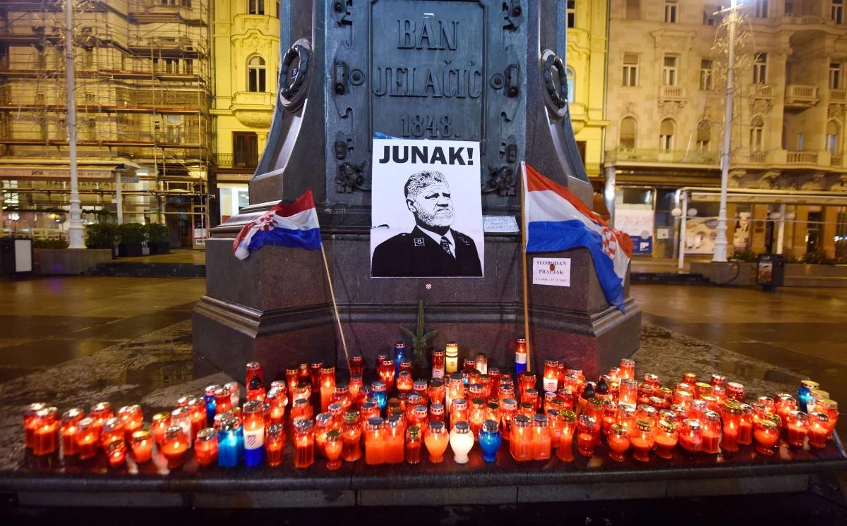 Lit candles and flags are placed in tribute to General Slobodan Praljak in Zagreb on November 30, 2017, after the Bosnian Croat war criminal took his own life in front of United Nations war crimes judges, apparently drinking poison just after they upheld his 20-year jail term for atrocities committed during the Balkans conflict. (AFP)