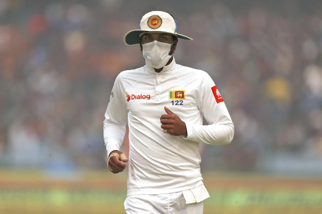 Sri Lanka’s captain Dinesh Chandimal fields wearing an anti-pollution mask during the second day of their third test cricket match against India in New Delhi on Sunday, December 3. (AP)