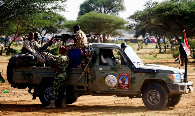 Sudanese members of the Rapid Support Forces ride in a pickup truck in the town of Umm Al-Qura. (File photo/AFP)