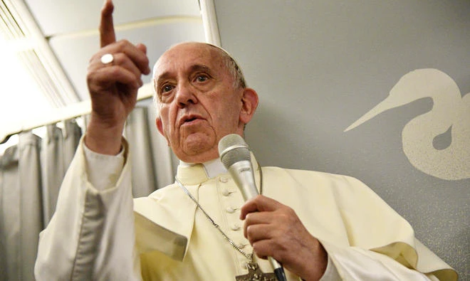 Pope Francis gestures during a news conference on board of a plane on December 2, 2017, during a flight back from a seven-day trip to Myanmar and Bangladesh. (AFP)