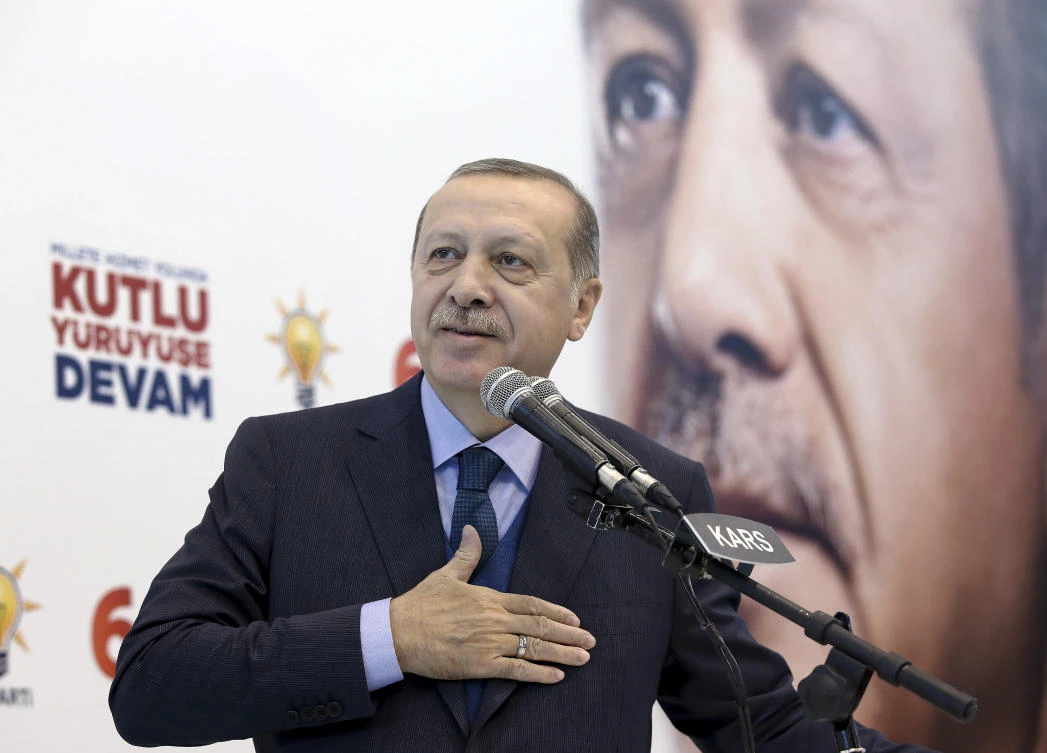 Turkey’s President Recep Tayyip Erdogan acknowledges supporters of his ruling Justice and Development Party (AKP) during a rally in Kars, eastern Turkey, Saturday, Dec. 2, 2017. (Yasin Bulbul/LPool via AP)