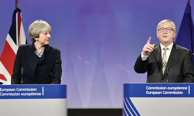 British Prime Minister Theresa May, left, and European Commission chief Jean-Claude Juncker address a media conference as they meet for Brexit negotiations on Monday at the European Commission in Brussels. (AFP)
