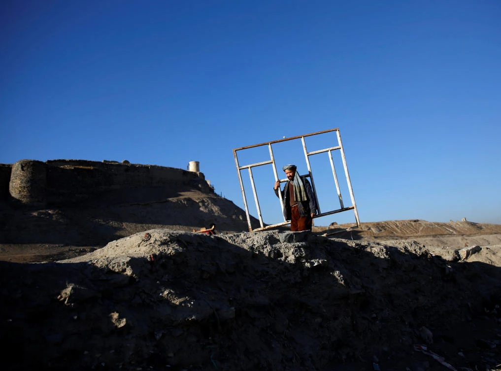 An Afghan man carries a window in Kabul, Afghanistan. (Reuters/Mohammad Ismail)