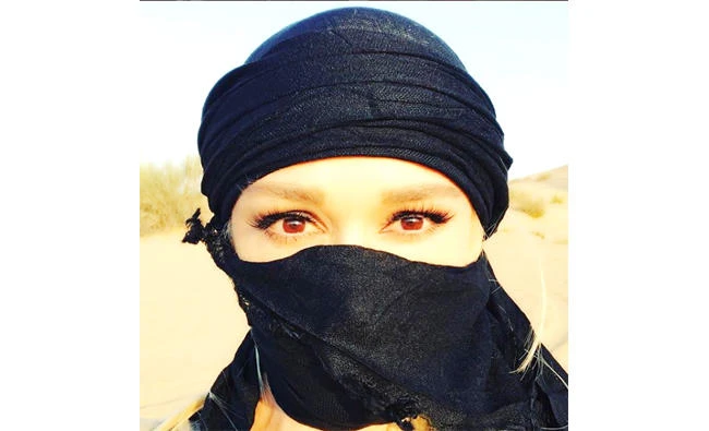 Gwen Stefani posted an Instagram photo Sunday of herself in the desert with her hair and most of her face covered up, shielding herself from
the dust.